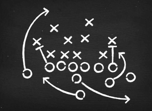 American football coach planning strategy on a field diagram with Xs and Os